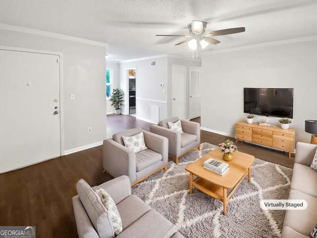 living area with a ceiling fan, crown molding, wood finished floors, and baseboards