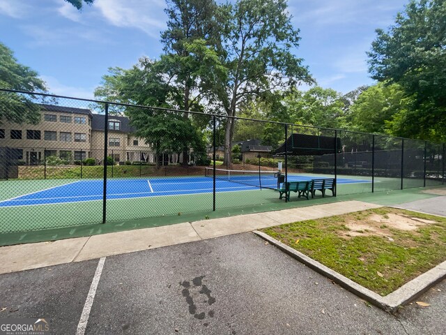 view of tennis court featuring fence