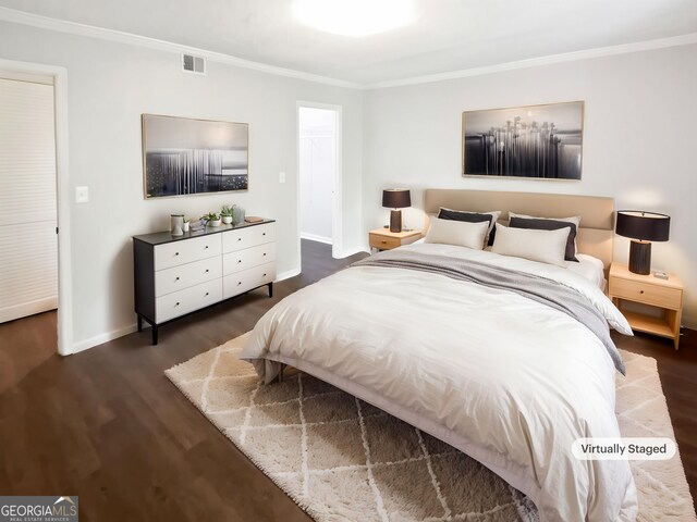 bedroom with ornamental molding, wood finished floors, and baseboards