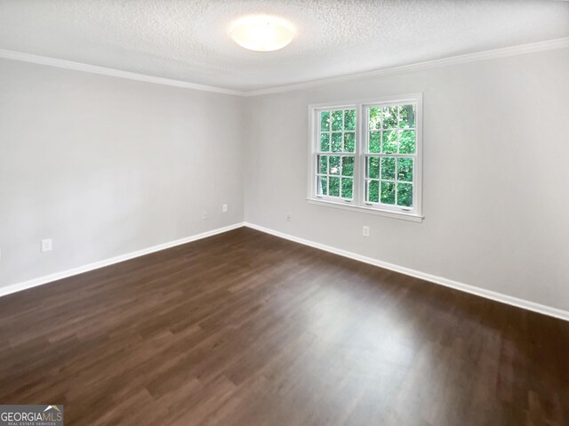 empty room with ornamental molding, dark wood-style floors, baseboards, and a textured ceiling