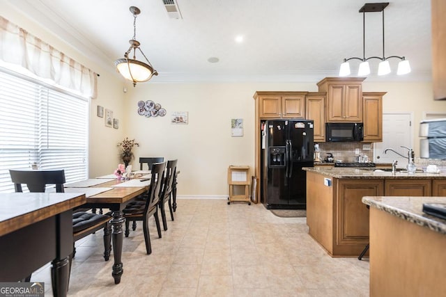 kitchen with black appliances, a sink, brown cabinets, ornamental molding, and tasteful backsplash