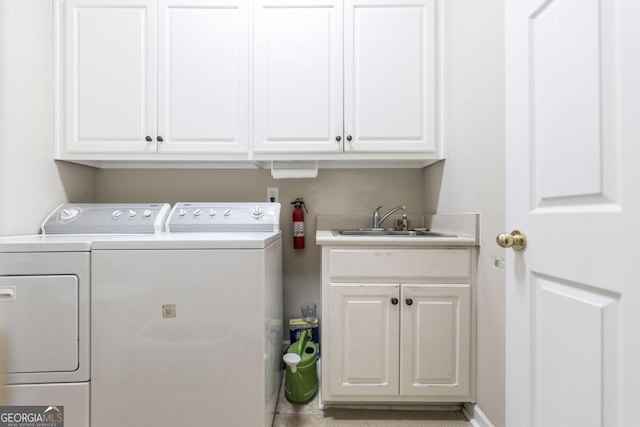 washroom featuring washer and clothes dryer and cabinet space