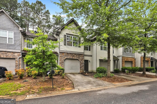 547 SE Tufton Trl SE, Atlanta, GA 30354 - multi unit property with stone siding, concrete driveway, and an attached garage