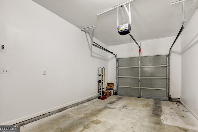 547 SE Tufton Trl SE, Atlanta, GA 30354 - garage with a garage door opener and baseboards