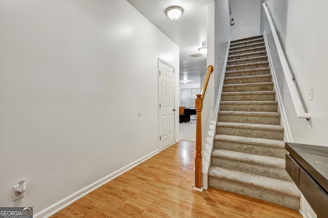 547 SE Tufton Trl SE, Atlanta, GA 30354 - staircase with wood finished floors and baseboards