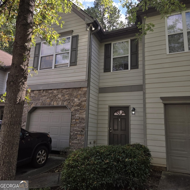 547 SE Tufton Trl SE, Atlanta, GA 30354 - view of front of house featuring an attached garage and stone siding