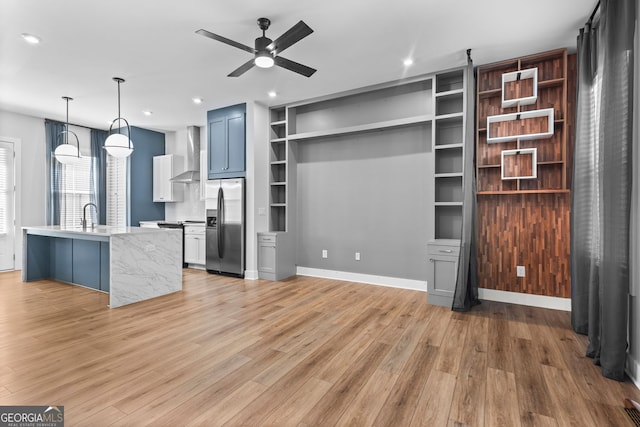 4462 Dandelion Ln, Atlanta, GA 30342 - unfurnished living room featuring a ceiling fan, light wood-style flooring, a sink, recessed lighting, and built in shelves
