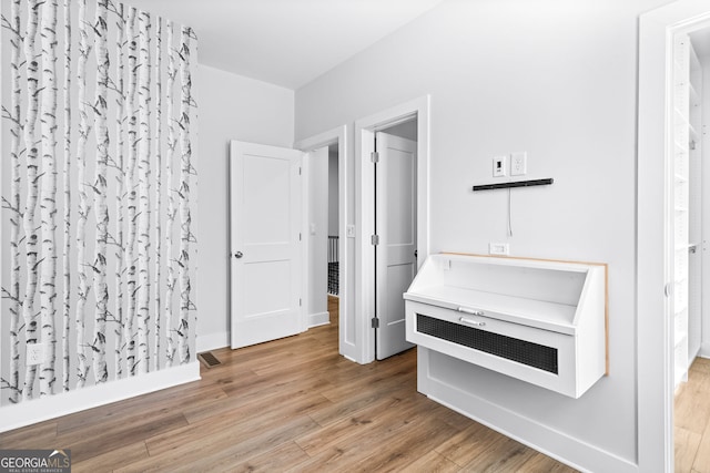 4462 Dandelion Ln, Atlanta, GA 30342 - unfurnished bedroom featuring wood finished floors and baseboards