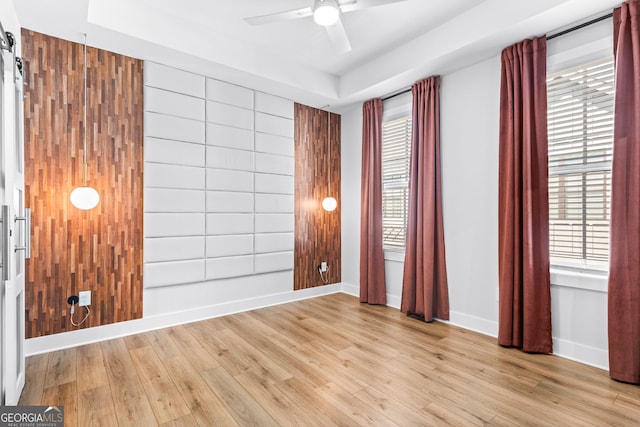 4462 Dandelion Ln, Atlanta, GA 30342 - empty room with healthy amount of natural light, light wood-style flooring, ceiling fan, and baseboards