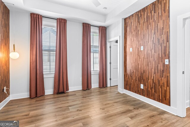 4462 Dandelion Ln, Atlanta, GA 30342 - empty room with baseboards, light wood-style flooring, and a tray ceiling