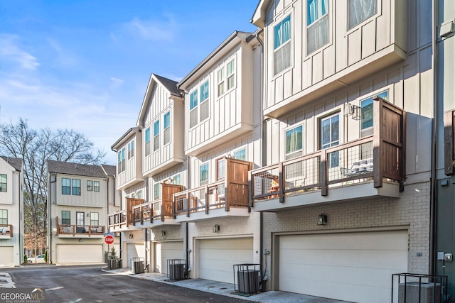 4462 Dandelion Ln, Atlanta, GA 30342 - view of building exterior with an attached garage and cooling unit