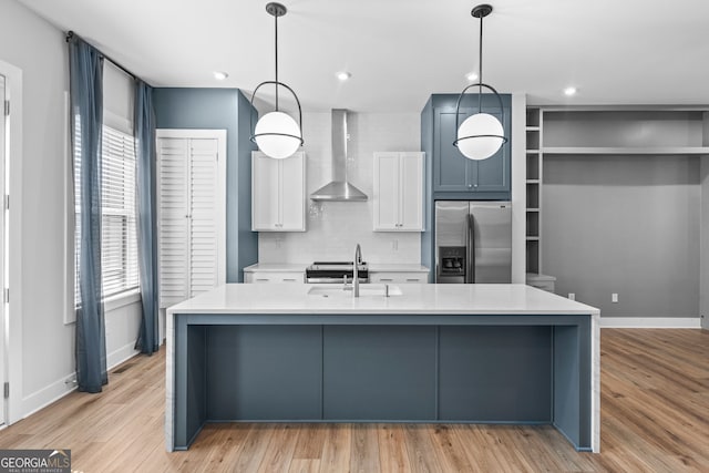 4462 Dandelion Ln, Atlanta, GA 30342 - kitchen with stainless steel refrigerator with ice dispenser, wall chimney range hood, light countertops, baseboards, and recessed lighting