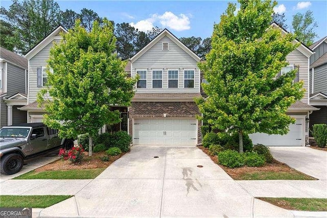 6237 Thorncrest Dr Unit 10, Tucker, GA 30084 - view of front of property featuring an attached garage, driveway, and brick siding