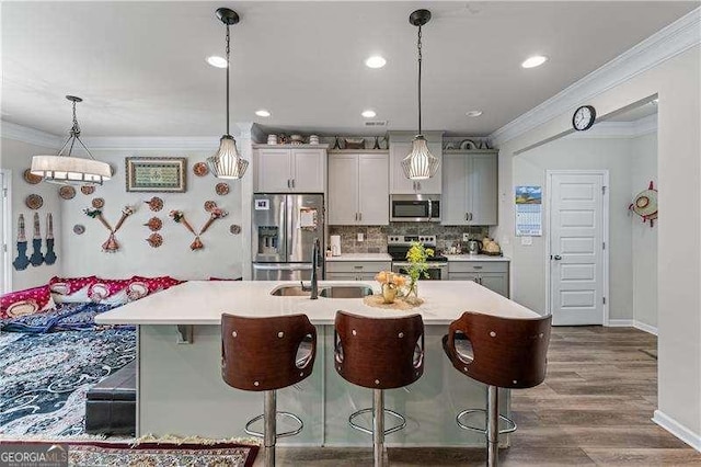 6237 Thorncrest Dr Unit 10, Tucker, GA 30084 - kitchen with stainless steel appliances, a sink, ornamental molding, a breakfast bar, and light countertops