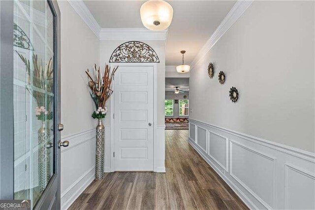 6237 Thorncrest Dr Unit 10, Tucker, GA 30084 - entrance foyer with crown molding, dark wood finished floors, a decorative wall, and a wainscoted wall