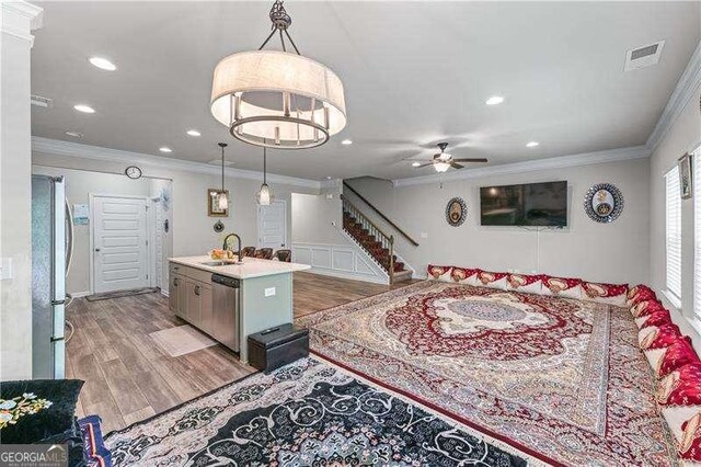 6237 Thorncrest Dr Unit 10, Tucker, GA 30084 - living room with ornamental molding, light wood-style floors, stairs, a ceiling fan, and recessed lighting