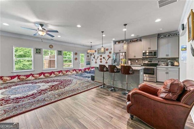 6237 Thorncrest Dr Unit 10, Tucker, GA 30084 - living room featuring ceiling fan, wood finished floors, recessed lighting, and crown molding