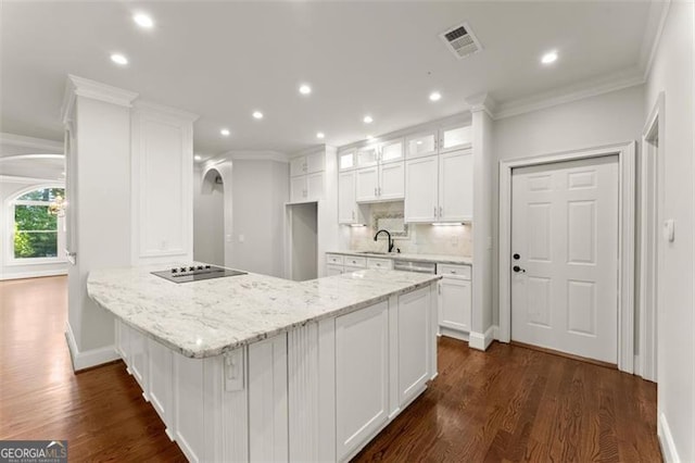 5816 Chamblee Dunwoody, Atlanta, GA 30338 - kitchen with arched walkways, white cabinets, recessed lighting, a peninsula, and ornamental molding