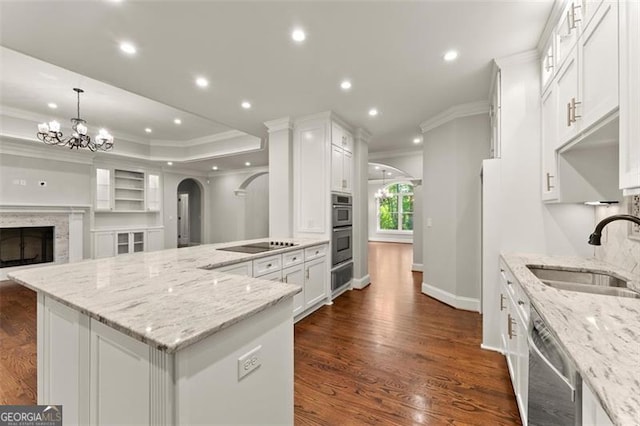 5816 Chamblee Dunwoody, Atlanta, GA 30338 - kitchen featuring a sink, appliances with stainless steel finishes, crown molding, arched walkways, and a chandelier