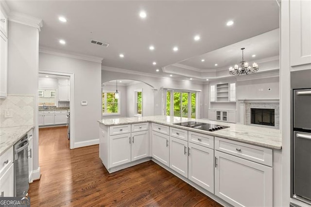 5816 Chamblee Dunwoody, Atlanta, GA 30338 - kitchen featuring black electric stovetop, crown molding, arched walkways, white cabinets, and dark wood finished floors