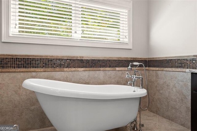 5816 Chamblee Dunwoody, Atlanta, GA 30338 - bathroom with tile walls, a freestanding tub, and wainscoting
