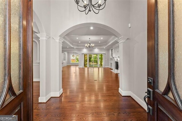 5816 Chamblee Dunwoody, Atlanta, GA 30338 - entrance foyer with a chandelier, arched walkways, dark wood finished floors, a tray ceiling, and baseboards