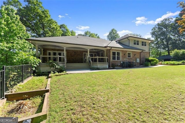 5816 Chamblee Dunwoody, Atlanta, GA 30338 - back of house featuring a garden, a lawn, and brick siding