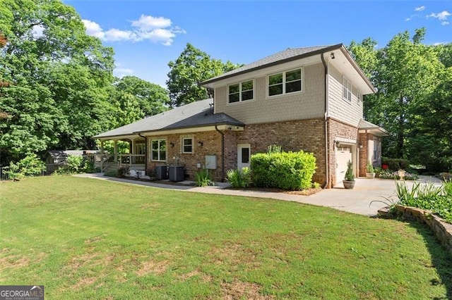 5816 Chamblee Dunwoody, Atlanta, GA 30338 - back of house featuring concrete driveway, an attached garage, brick siding, and a lawn