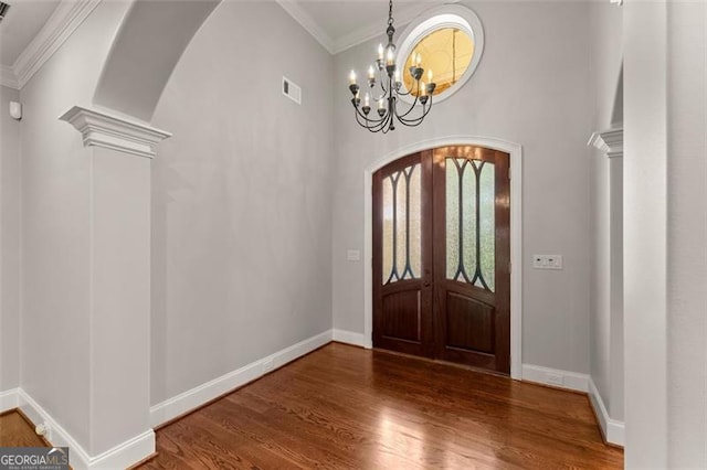 5816 Chamblee Dunwoody, Atlanta, GA 30338 - foyer entrance featuring crown molding, arched walkways, wood finished floors, baseboards, and a chandelier