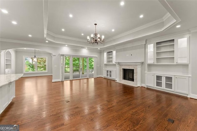 5816 Chamblee Dunwoody, Atlanta, GA 30338 - unfurnished living room featuring a tray ceiling, a chandelier, crown molding, a high end fireplace, and recessed lighting