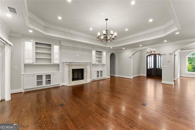 5816 Chamblee Dunwoody, Atlanta, GA 30338 - unfurnished living room with arched walkways, a chandelier, a tray ceiling, wood finished floors, and recessed lighting