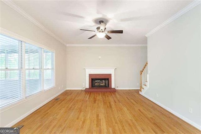 5065 Hickory Hills Dr, Woodstock, GA 30188 - unfurnished living room featuring stairway, light wood-style floors, a ceiling fan, a brick fireplace, and ornamental molding