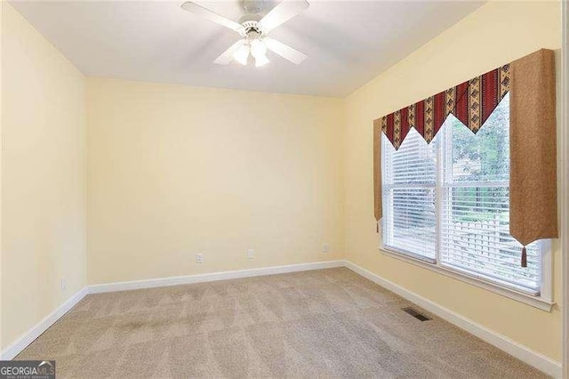 5065 Hickory Hills Dr, Woodstock, GA 30188 - empty room featuring light carpet, a ceiling fan, and baseboards