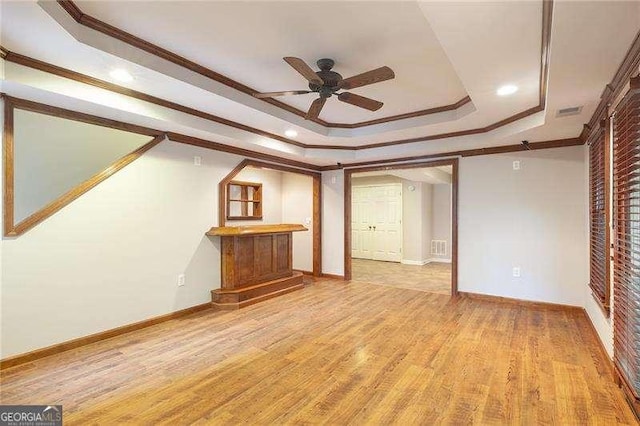 5065 Hickory Hills Dr, Woodstock, GA 30188 - unfurnished living room featuring a raised ceiling, ornamental molding, ceiling fan, light wood-style floors, and baseboards