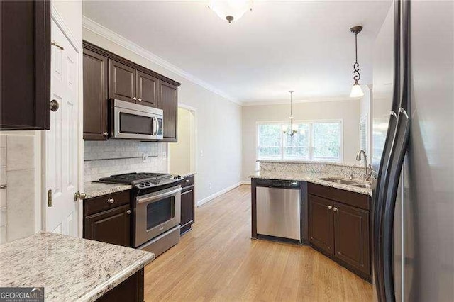 5065 Hickory Hills Dr, Woodstock, GA 30188 - kitchen with appliances with stainless steel finishes, a sink, dark brown cabinets, light wood-type flooring, and backsplash