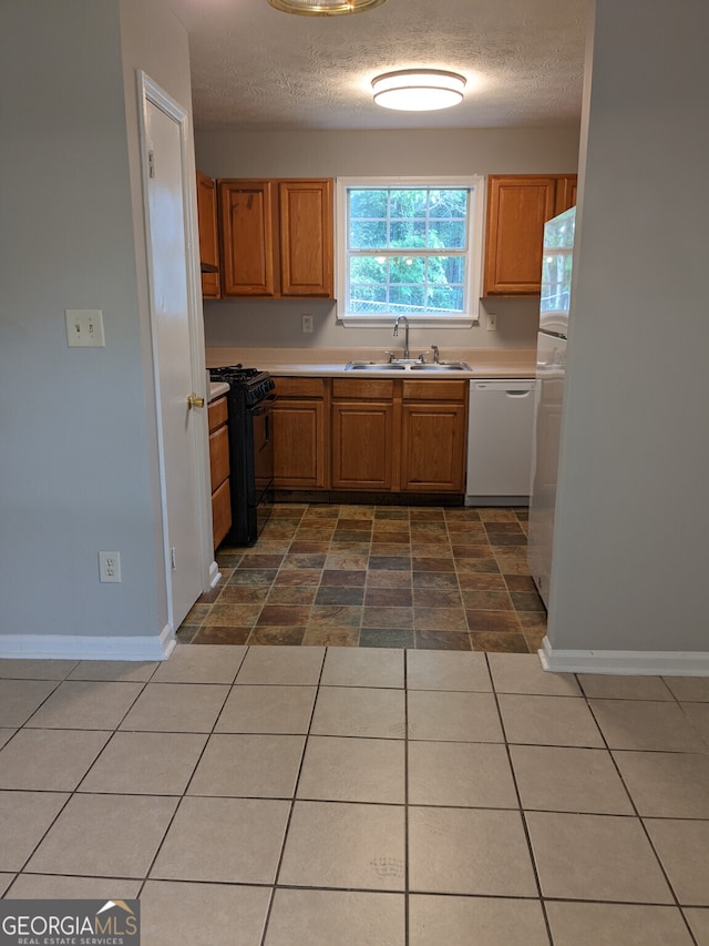 6260 Marbut Farms Ter, Lithonia, GA 30058 - kitchen featuring black range with gas stovetop, dishwasher, a sink, baseboards, and light countertops