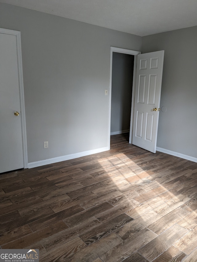 6260 Marbut Farms Ter, Lithonia, GA 30058 - spare room featuring dark wood-style floors and baseboards