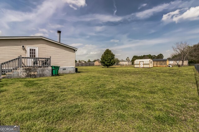 view of yard with a storage shed and an outdoor structure