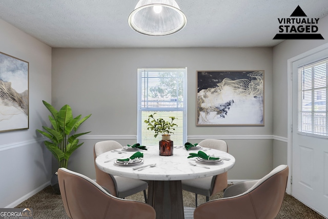 1436 Arbor Place Dr, Morrow, GA 30260 - carpeted dining space featuring baseboards and a textured ceiling