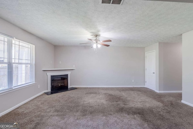 1436 Arbor Place Dr, Morrow, GA 30260 - unfurnished living room with a ceiling fan, carpet flooring, a fireplace with raised hearth, baseboards, and a textured ceiling