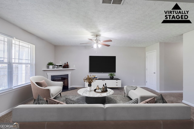 1436 Arbor Place Dr, Morrow, GA 30260 - carpeted living room featuring baseboards, ceiling fan, and a fireplace with flush hearth