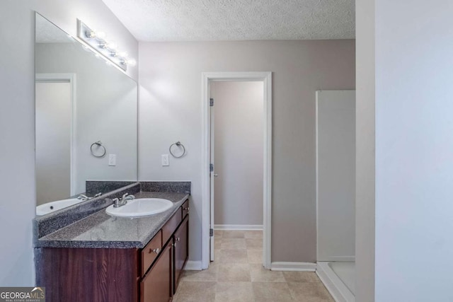 1436 Arbor Place Dr, Morrow, GA 30260 - bathroom featuring a textured ceiling, vanity, and baseboards