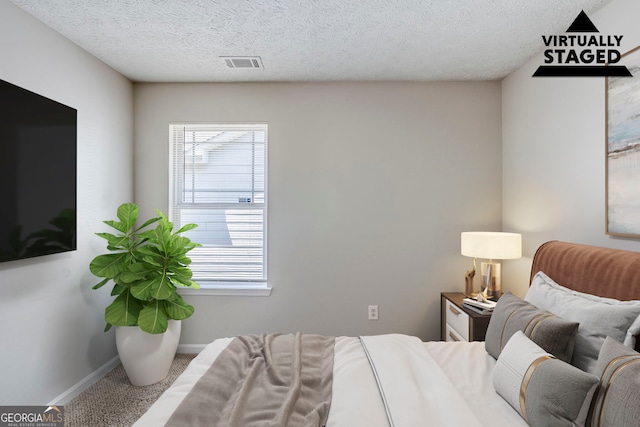 1436 Arbor Place Dr, Morrow, GA 30260 - carpeted bedroom with baseboards and a textured ceiling