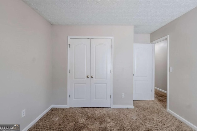 1436 Arbor Place Dr, Morrow, GA 30260 - unfurnished bedroom featuring carpet, a closet, baseboards, and a textured ceiling