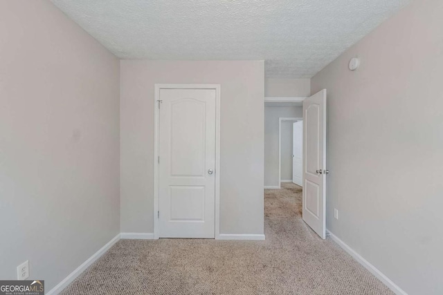 1436 Arbor Place Dr, Morrow, GA 30260 - unfurnished bedroom with carpet floors, a textured ceiling, and baseboards