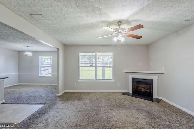 1436 Arbor Place Dr, Morrow, GA 30260 - unfurnished living room with carpet floors, a textured ceiling, a fireplace with raised hearth, a ceiling fan, and baseboards