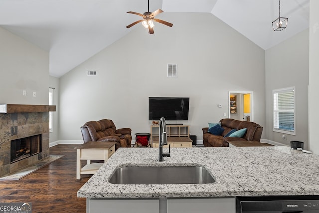 121 Bob Cat Trl, Mansfield, GA 30055 - kitchen featuring open floor plan, high vaulted ceiling, a ceiling fan, dark wood-style flooring, and light stone counters