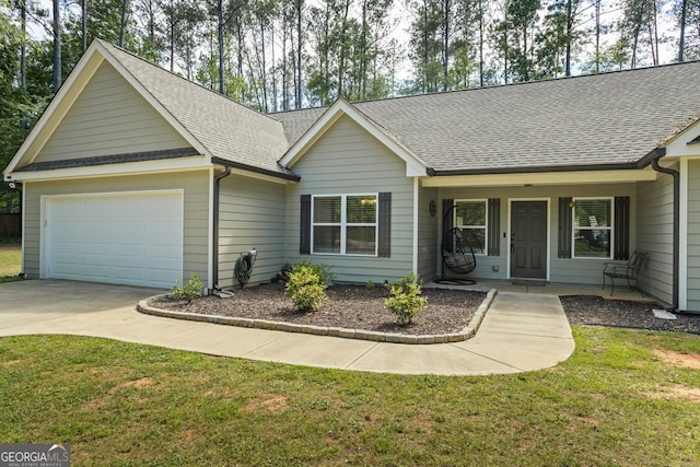 ranch-style home featuring a shingled roof, covered porch, concrete driveway, and a front lawn