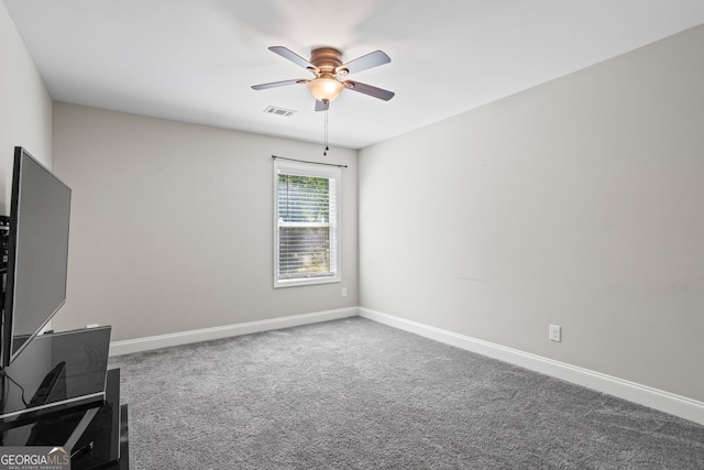 unfurnished room featuring a ceiling fan, carpet floors, and baseboards