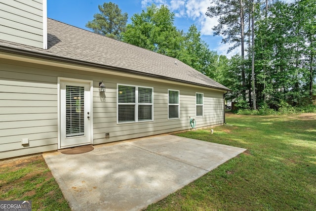 121 Bob Cat Trl, Mansfield, GA 30055 - rear view of property featuring a patio area, a shingled roof, and a lawn
